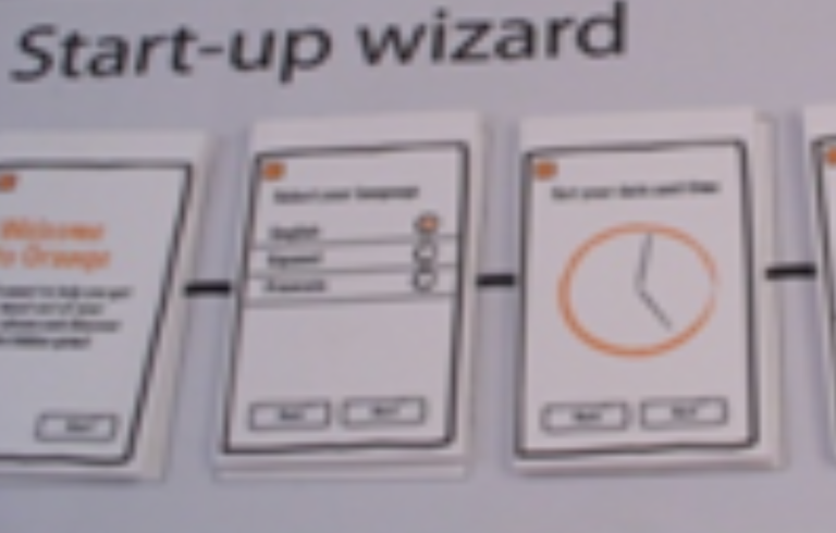 Illustration of a start-up wizard interface  with selection options and a progress indicator, sketched on paper cards.